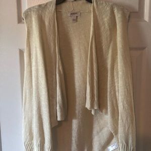 Cream colored pull over cardigan vest.